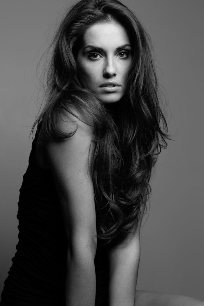 Black and white photo of beautiful model with long brown hair